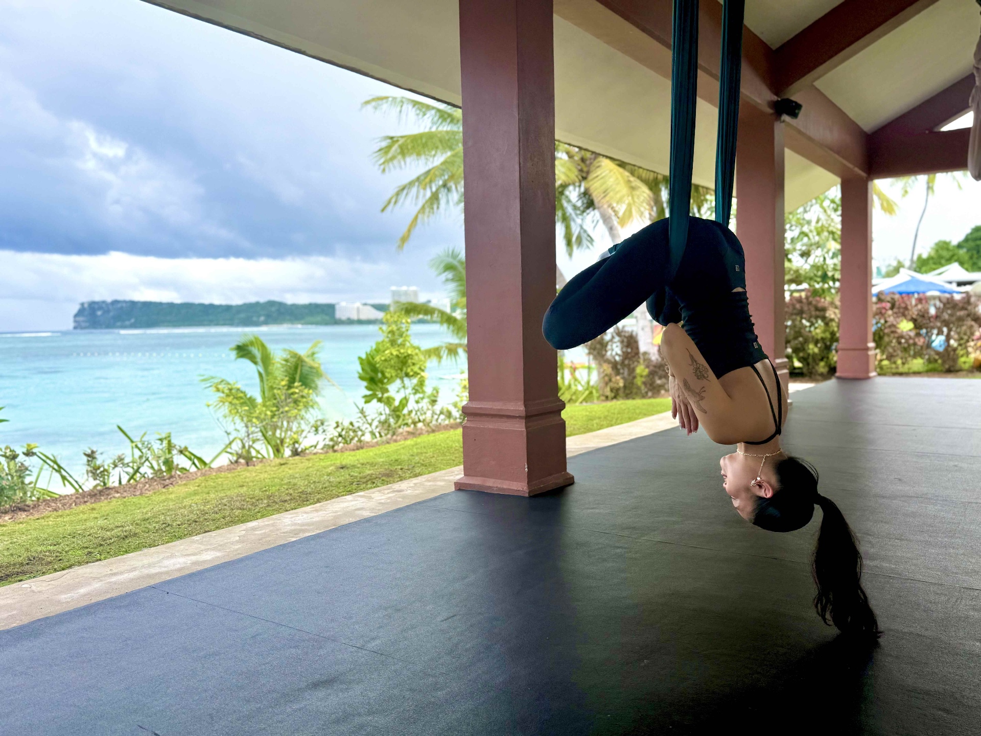 Aerial yoga overlooking the turquoise ocean in Tamuning, Guam